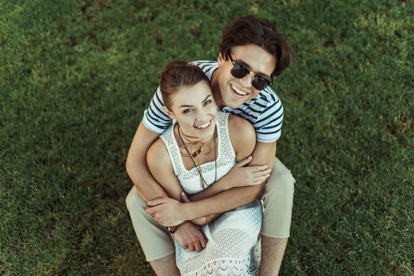 Smiling sweethearts hugging and looking at camera — Stock Photo