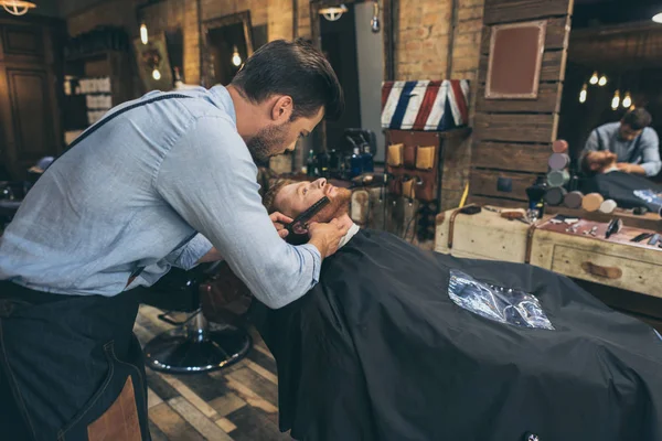 Перукар розчісує клієнтів бороду — Stock Photo