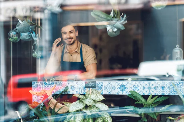 Florist talking on smartphone — Stock Photo