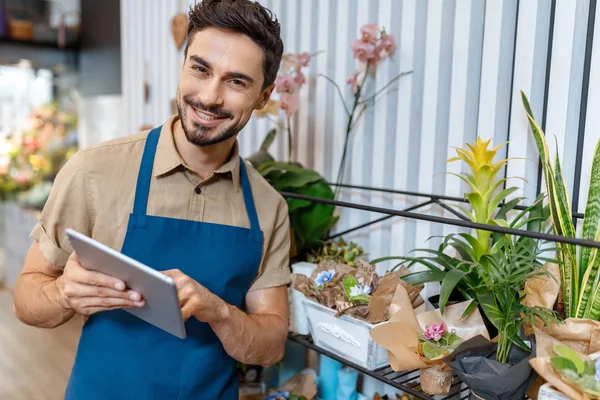 Male florist with digital tablet — Stock Photo
