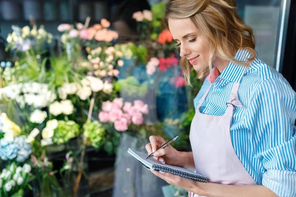 Florist macht sich Notizen — Stockfoto