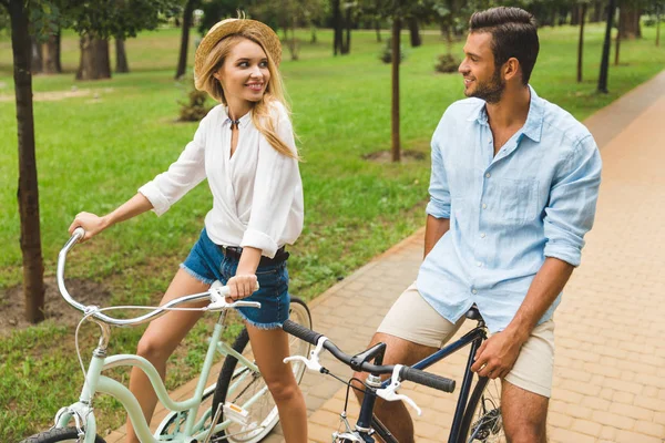 Happy couple riding bicycles — Stock Photo