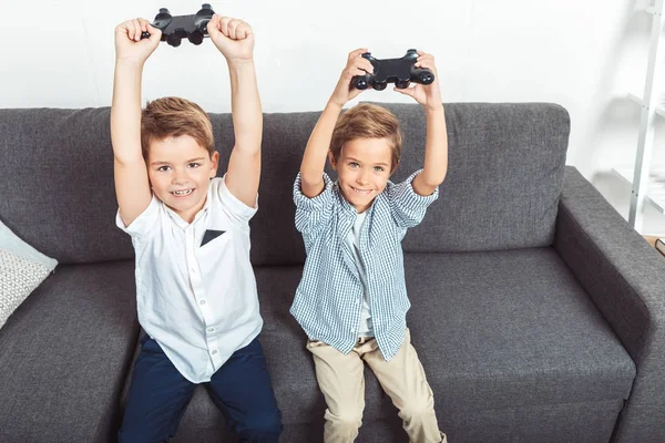 Boys playing with joysticks — Stock Photo
