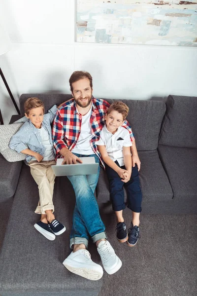 Pai com filhos usando laptop — Fotografia de Stock