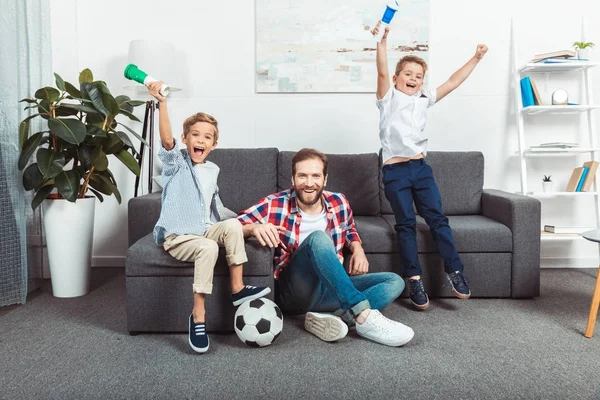 Family watching soccer match at home — Stock Photo