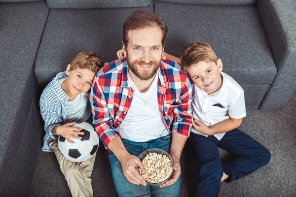 Family watching soccer match at home — Stock Photo