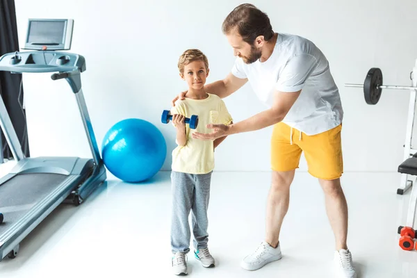 Father and son training with dumbbell — Stock Photo