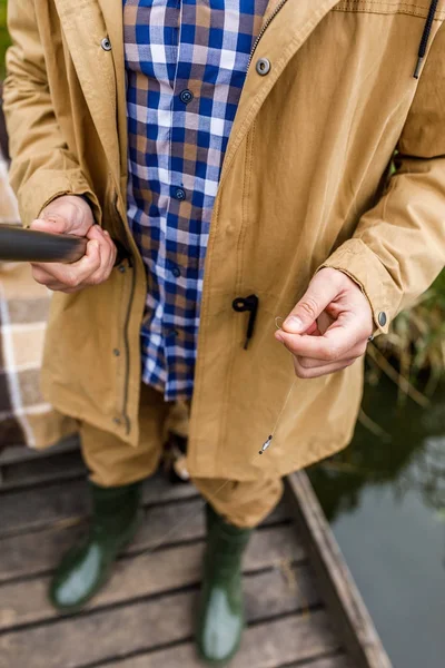 Fisherman with rod and hook — Stock Photo