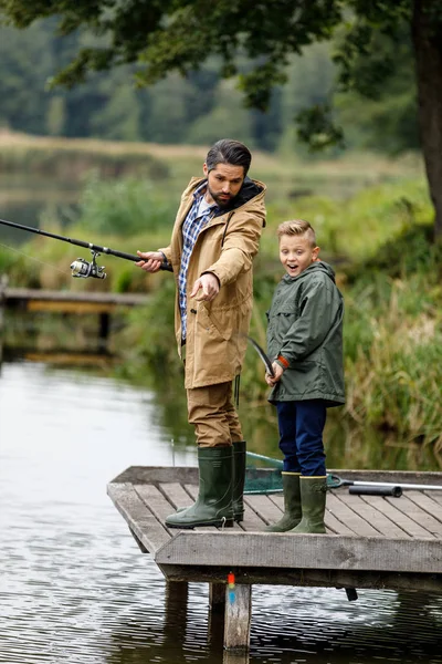 Father and son fishing on lake — Stock Photo
