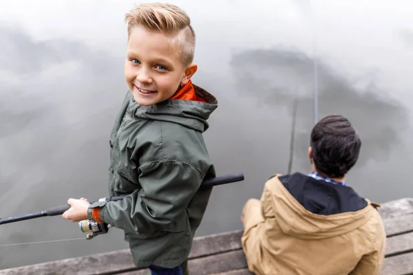 Father and son fishing with rods — Stock Photo