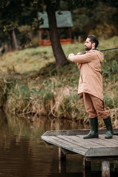 Fisherman fishing with rod — Stock Photo