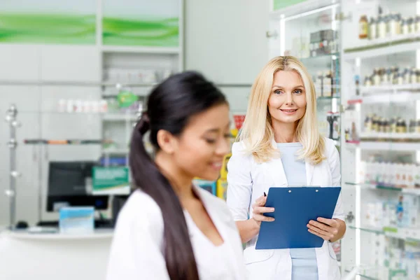 Multiethnic pharmacists in drugstore — Stock Photo