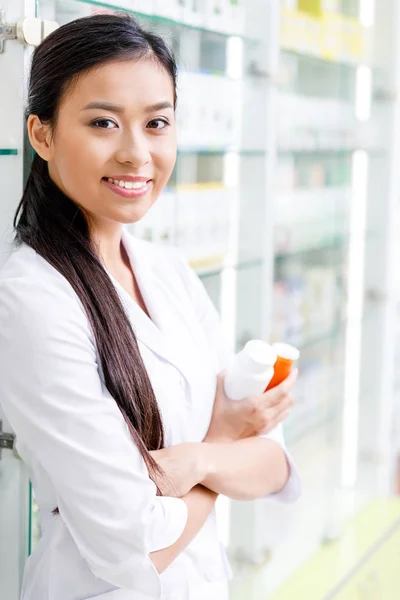 Pharmacist with medication in drugstore — Stock Photo