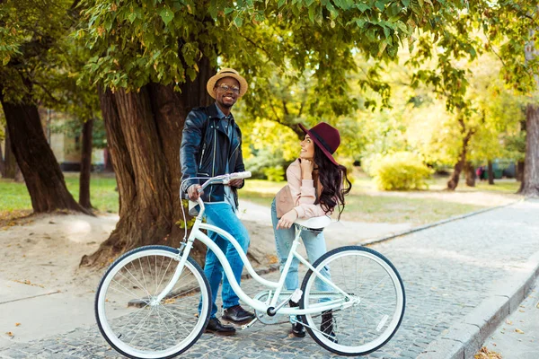 Feliz casal de pé e inclinando-se na bicicleta — Fotografia de Stock