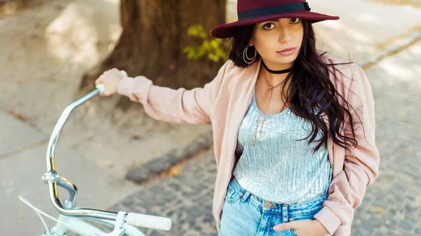 Femme en chapeau debout avec vélo — Photo de stock