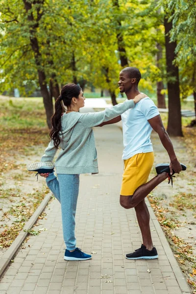 Couple stretching on road — Stock Photo