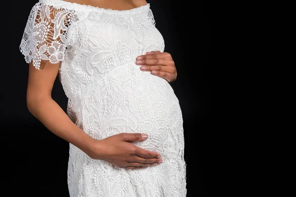 Pregnant woman touching belly — Stock Photo