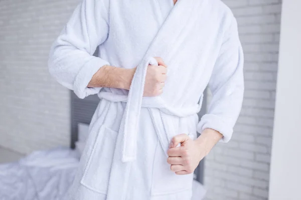 Mid section of man wearing bathrobe at home — Stock Photo