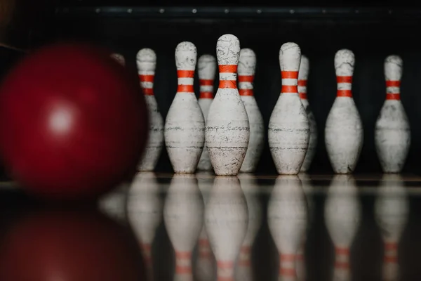 Grungy birilli da bowling con palla rossa in primo piano — Foto stock