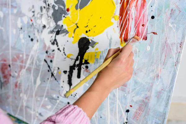 Cropped image of female artist painting in workshop — Stock Photo