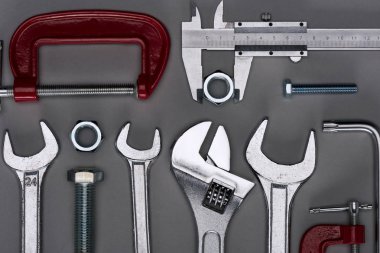top view of set of  various work tools on grey clipart