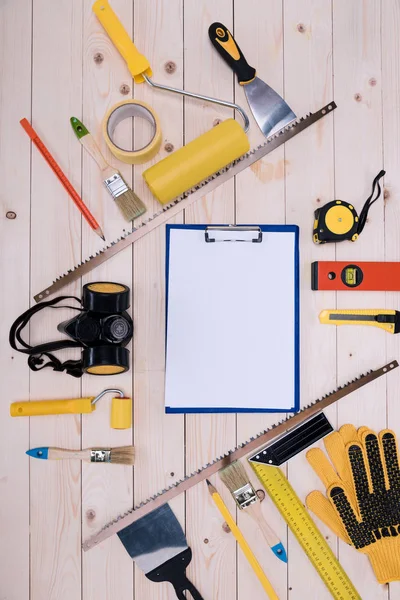 Top view of set of construction tools and blank clipboard — Stock Photo, Image