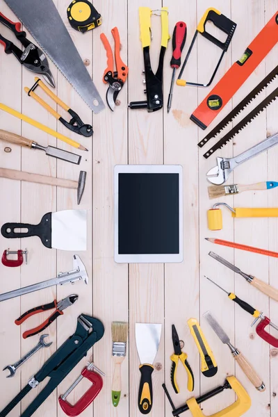 Top view of different tools with digital tablet on wooden tabletop — Stock Photo, Image