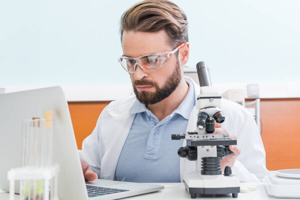 scientist working with microscope 