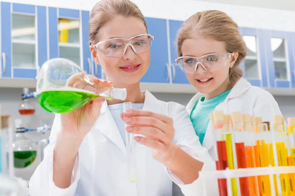 Scientist and girl with tubes — Stock Photo, Image