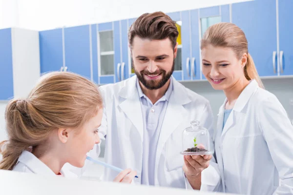Teachers and student in lab — Free Stock Photo
