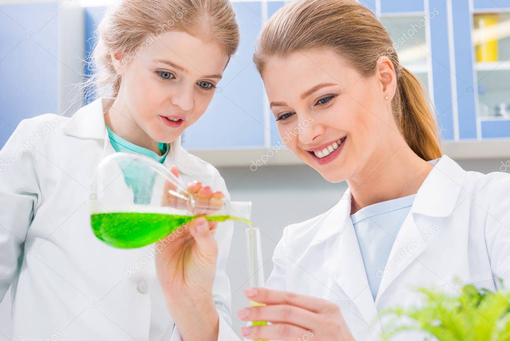 Teacher and student in chemical lab 