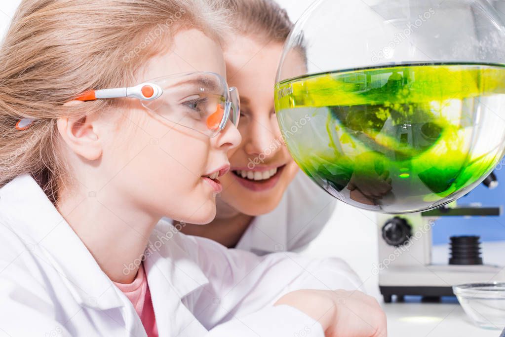 Teacher and student in chemical lab 