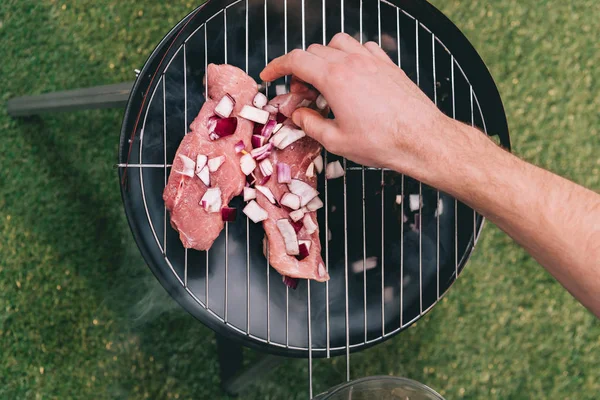 Man roasting meat — Stock Photo, Image