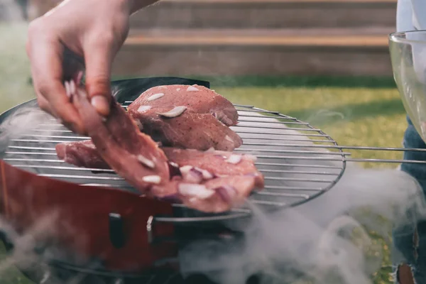 Man roasting meat — Stock Photo, Image