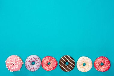 Several donuts with various glaze  clipart