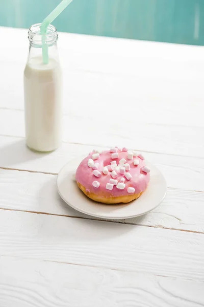 Donut with pink icing and milkshake — Stock Photo, Image