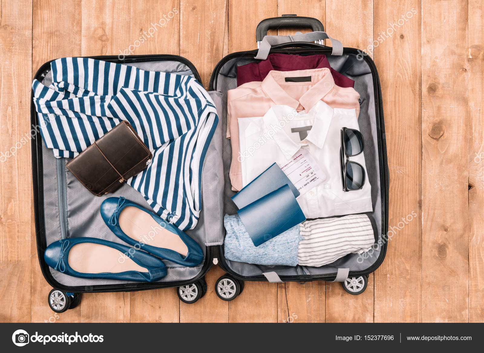 Traveler's accessories in open luggage ??? Stock Photo ?? DimaBaranow