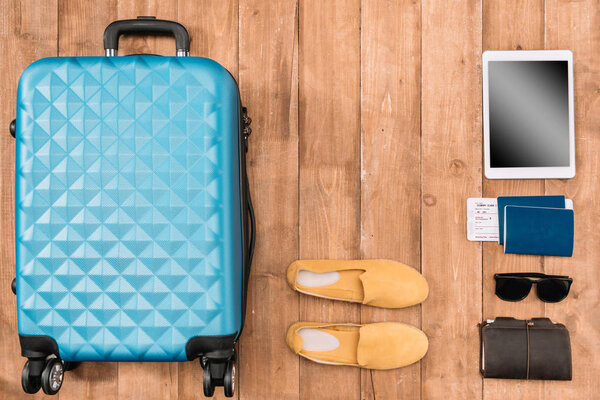 Flat lay with travel accessories on the floor 