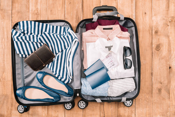 traveler's accessories in open luggage  
