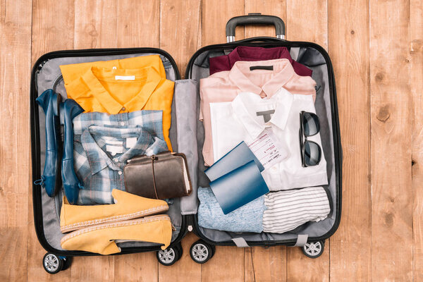 traveler's accessories in open luggage 