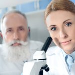 Scientists in white coats in lab