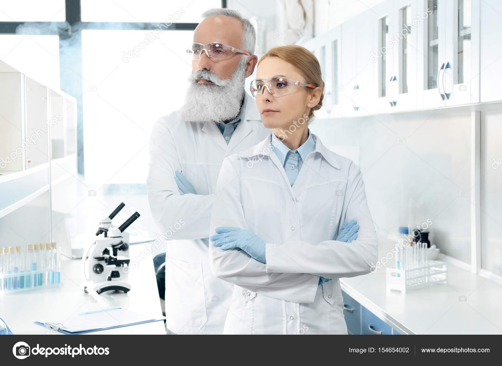 Scientists in white coats in lab — Stock Photo © DimaBaranow 154654002