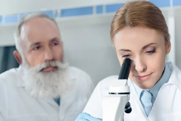 Scientists in white coats in lab — Stock Photo, Image