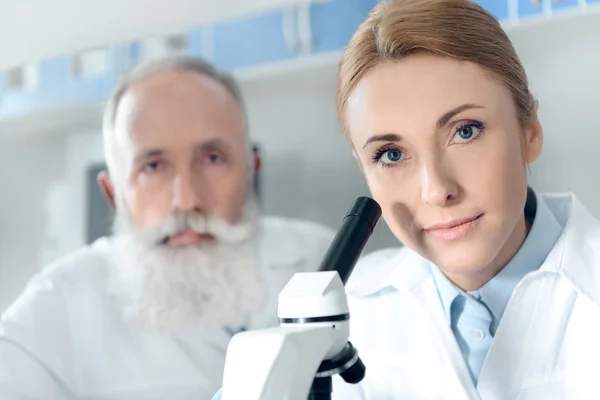 Scientists in white coats in lab — Free Stock Photo