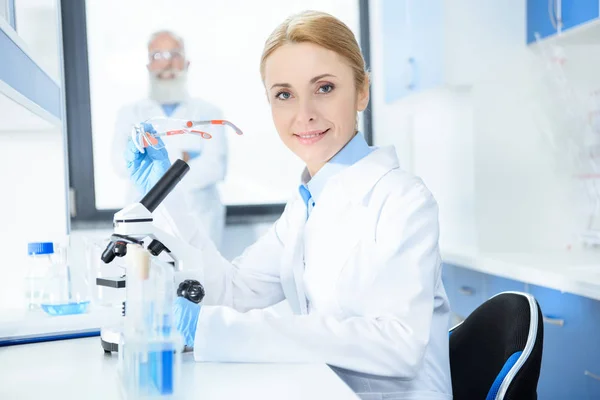 Scientist working with microscope — Stock Photo, Image