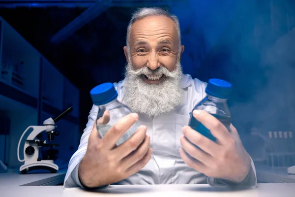 Scientist holding bottles with reagents — Stock Photo, Image