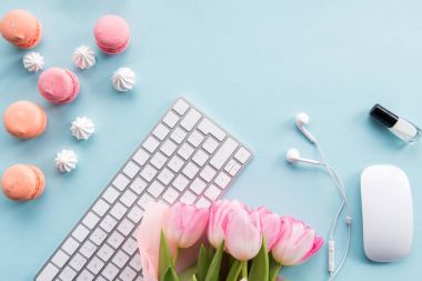 keyboard, macarons and flowers on tabletop clipart