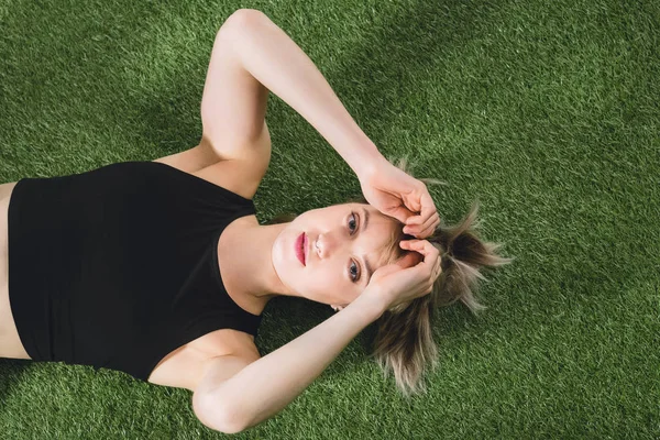 Caucasian girl lying on grass — Free Stock Photo