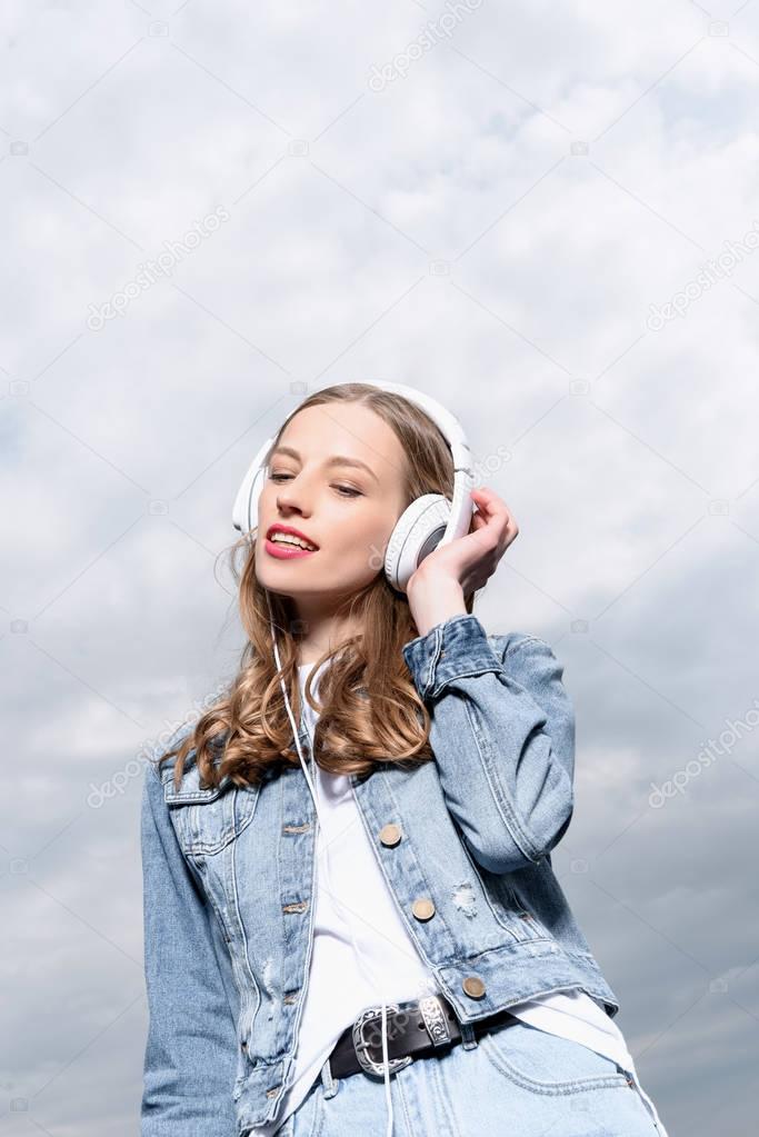 girl listening music in headphones