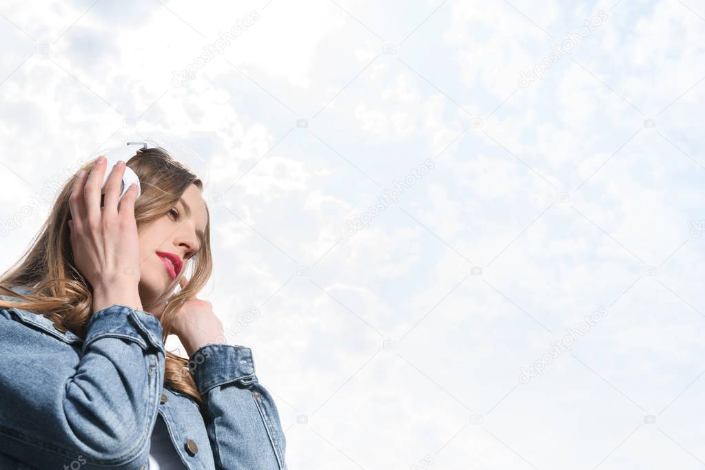 pensive girl listening music in headphones